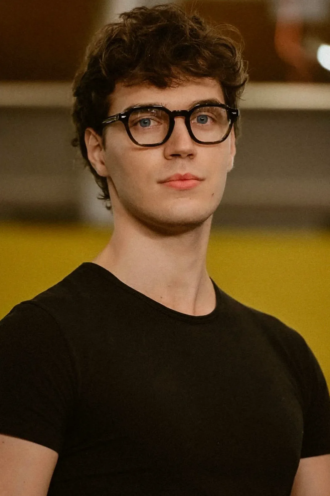 Portrait of Francesco Scarparo with thick-framed glasses and a black t-shirt